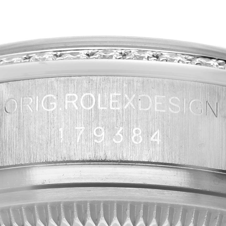 The image shows a close-up of the side engraving on the bezel of a Rolex Datejust 179384 Women's Stainless Steel Blue Dial watch.
