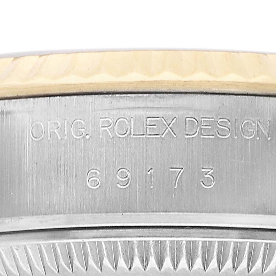 The image shows a close-up of the Rolex Datejust 69173 Women's Stainless Steel Champagne Dial model's side, highlighting the engraved design and serial number.