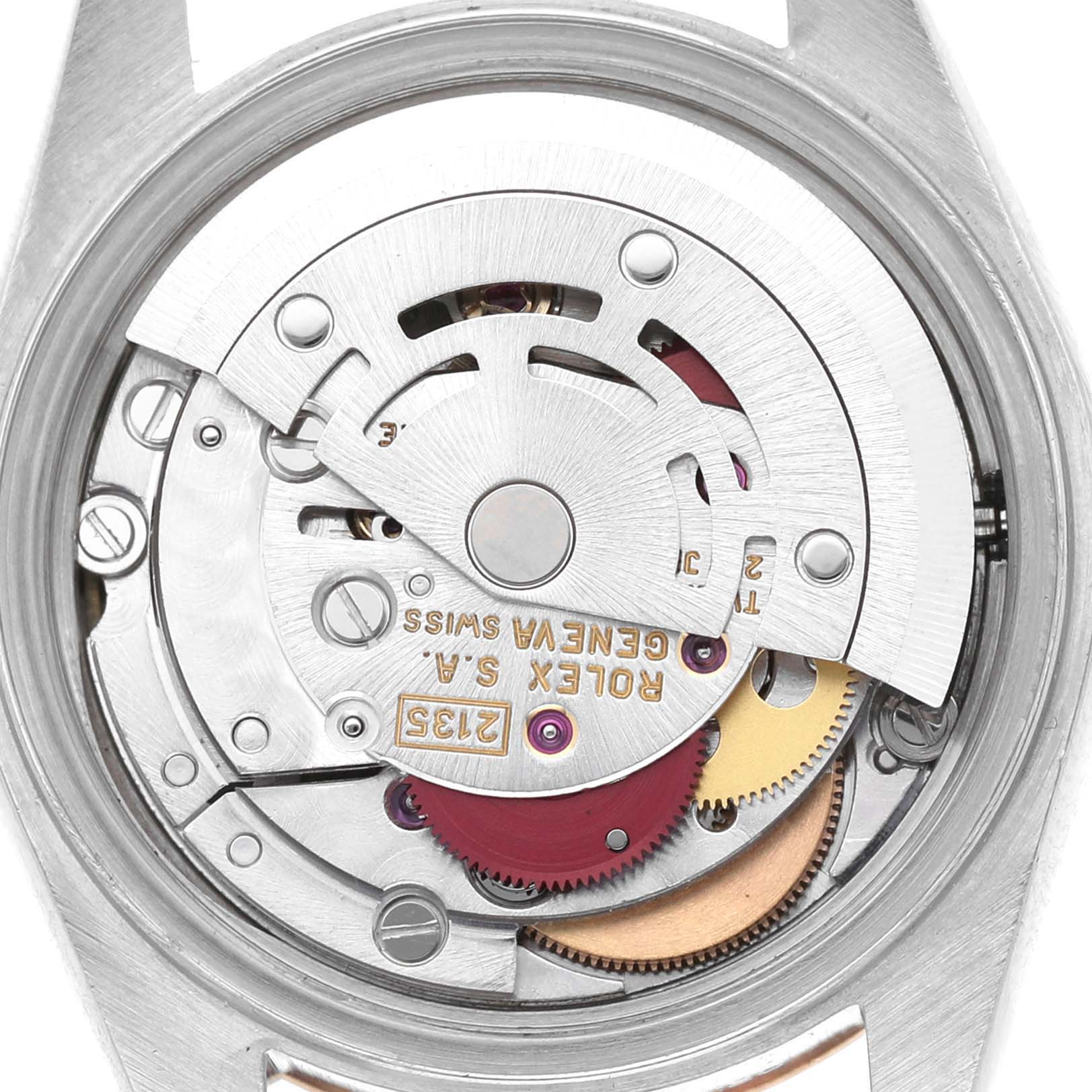 The image shows the internal mechanical movement of the Rolex Datejust 69173 Women's Stainless Steel Champagne Dial watch from a rear angle, highlighting gears and components.