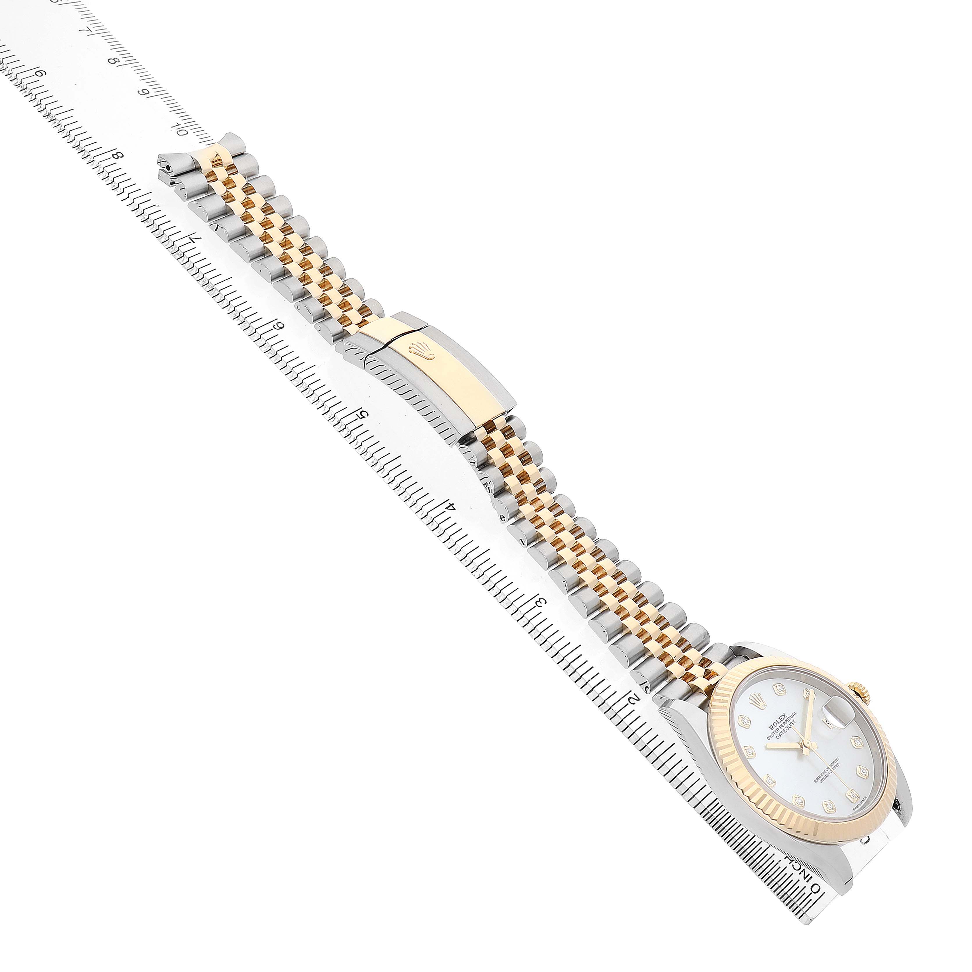 The Rolex Datejust 41 126333 Men's Steel and Gold (two tone) Mother of Pearl Dial is shown from a side angle, displaying the bracelet, clasp, and part of the watch face against a ruler.