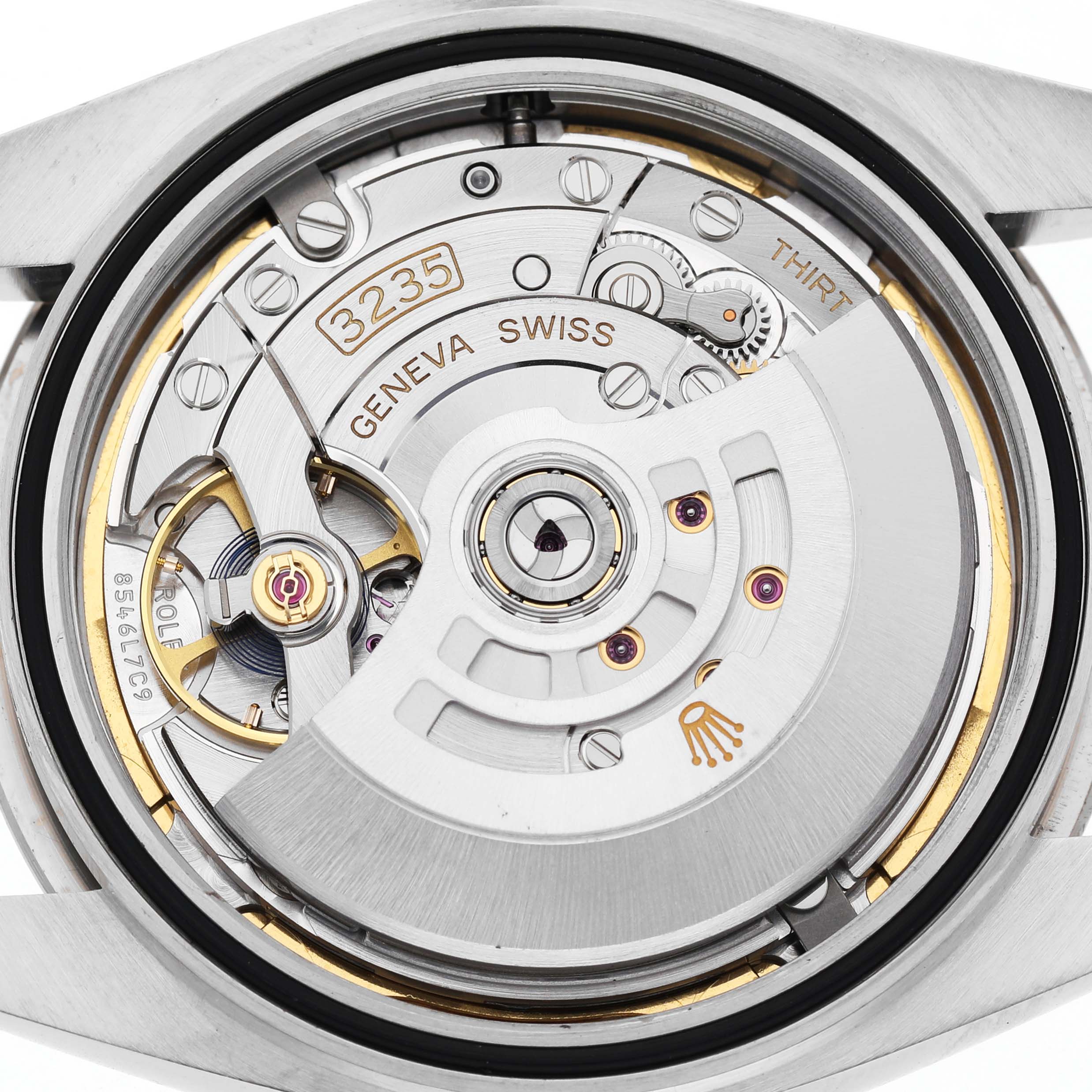 The image shows the movement of a Rolex Datejust 41 126334 Men's Stainless Steel Blue Dial, showcasing its intricate components and rotor from the back.