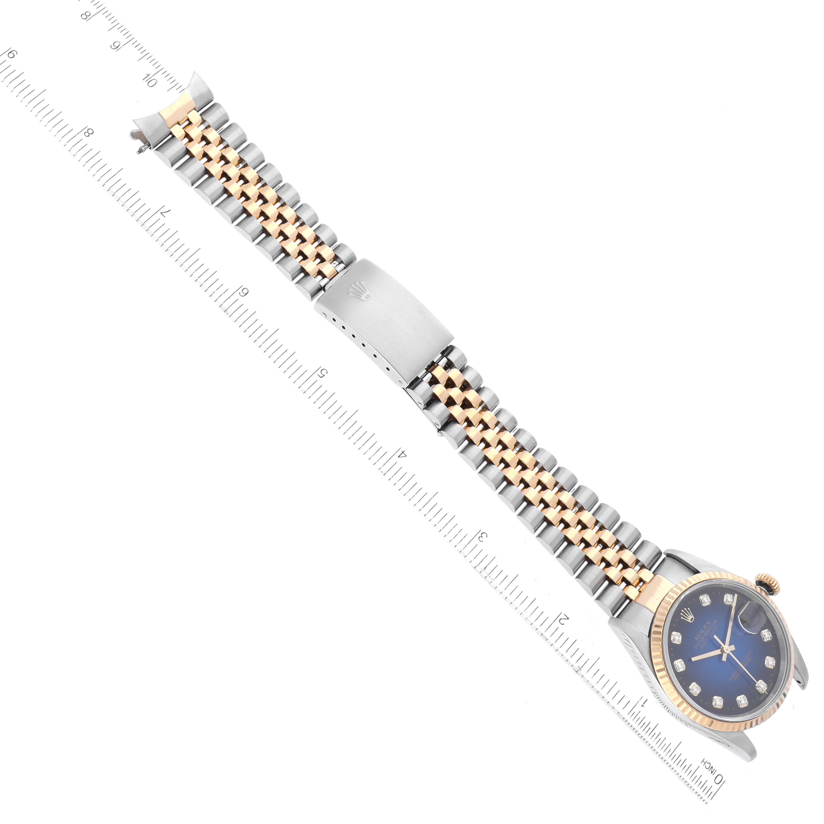 The Rolex Datejust 16233 Men's Steel and Gold (two tone) Blue Dial 16233 Men's Steel and Gold (two tone) Blue Dial watch is shown from a top-down angle, featuring its two-tone bracelet and a portion of its blue dial.