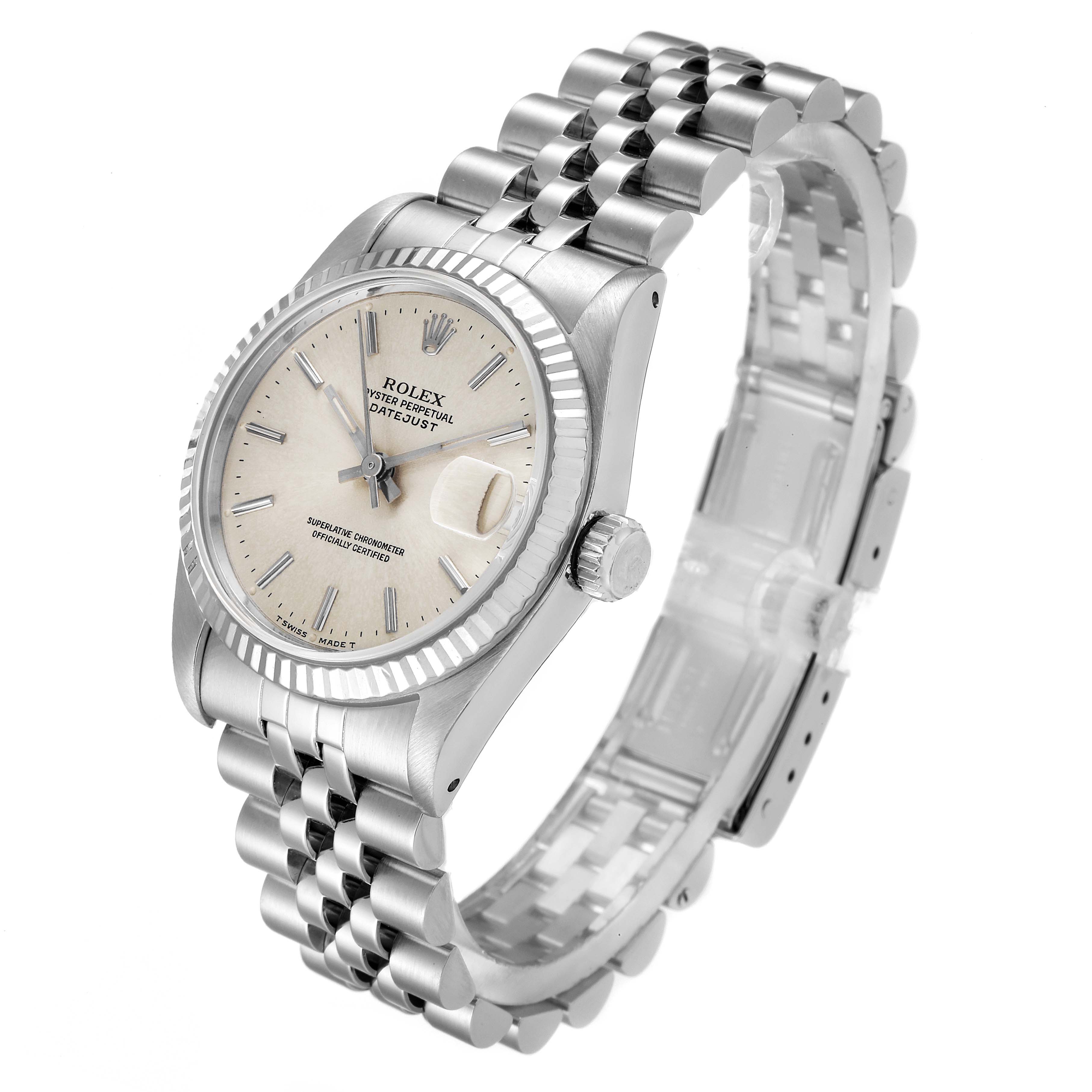 The Mid-Size Rolex watch is shown at an angled view, displaying the face, bezel, crown, and part of the bracelet.