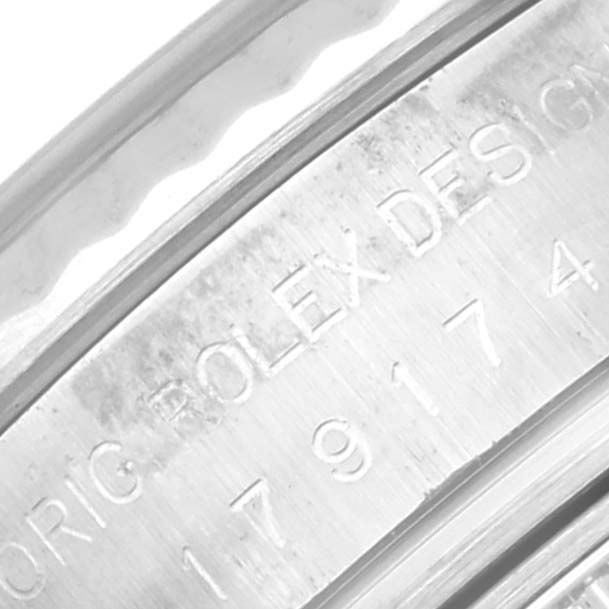 This image shows a close-up of the engraved serial number on the side of the case of a Rolex Datejust 179174 Women's Stainless Steel Black Dial 179174 Women's Stainless Steel Black Dial watch.