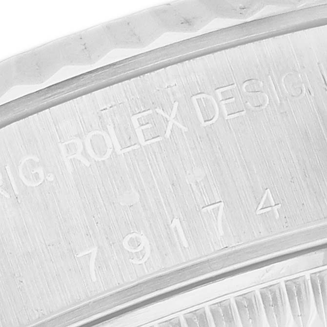 The image shows an engraved close-up of the case side of a Rolex Datejust 79174 Women's Stainless Steel Mother of Pearl Dial 79174 Women's Stainless Steel Mother of Pearl Dial watch.