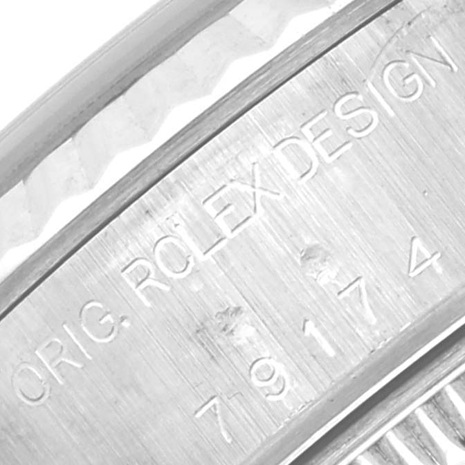 This close-up image shows the engraving on the side of the bezel of a Rolex Datejust 79174 Women's Stainless Steel Silver Dial 79174 Women's Stainless Steel Silver Dial watch.