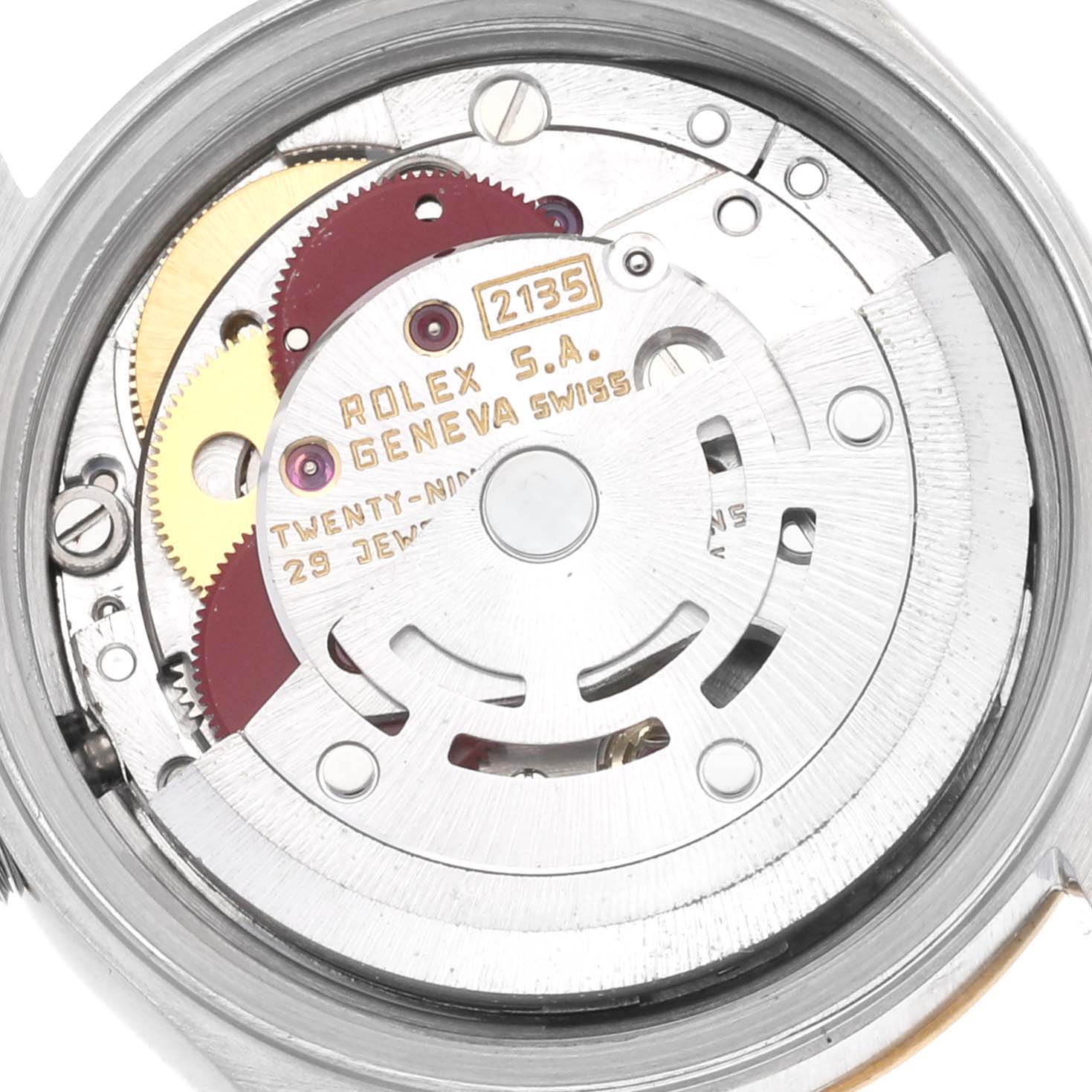 The image shows the movement of a Rolex Datejust model number 69173, focusing on the intricate gears and components inside the watch.