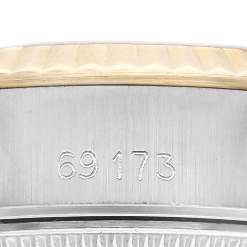 The image shows a close-up view of the side of a Rolex Datejust model, number 69173, focusing on the engraved model number and part of the bezel.