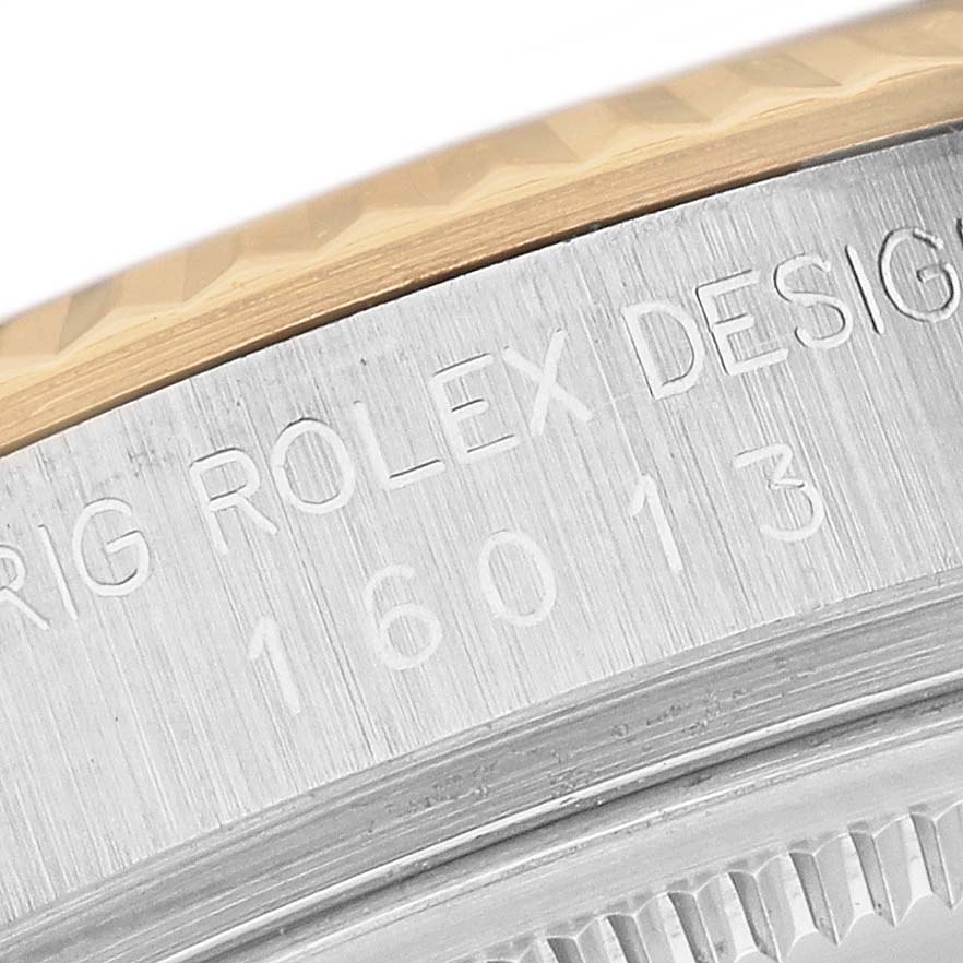 The image shows the side view of a Rolex Vintage Collection 16013 Men's Steel and Gold (two tone) White Dial watch, highlighting the engraved serial and design numbers on the case.