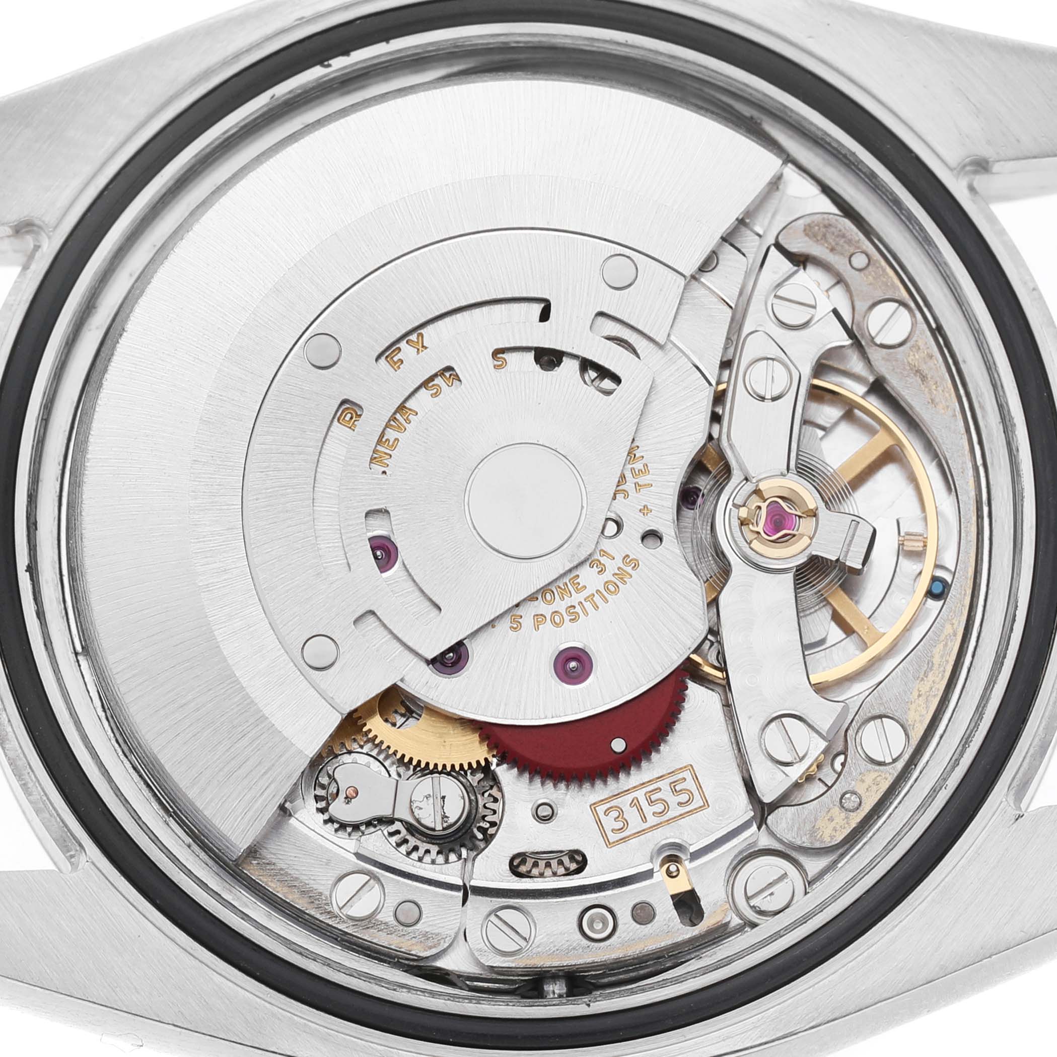 The image shows the exposed movement of a Rolex Datejust 116233 Men's Stainless Steel Champagne Dial watch, highlighting its intricate mechanical components.