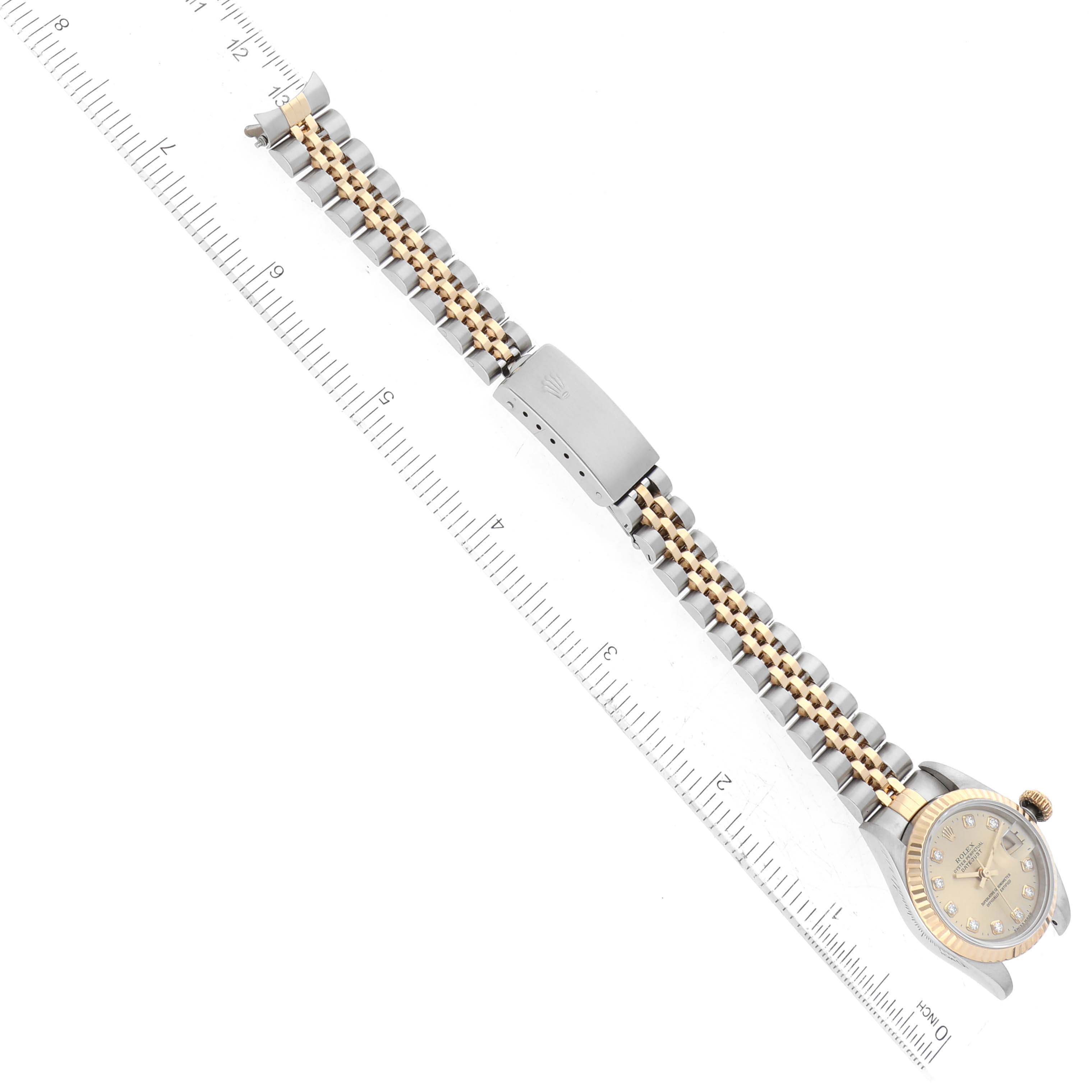 The image shows a Rolex Datejust 69173 Women's Steel and Gold (two tone) Champagne Dial 69173 Women's Steel and Gold (two tone) Champagne Dial watch laid flat with a full view of its band, face, and clasp, alongside a ruler for scale.