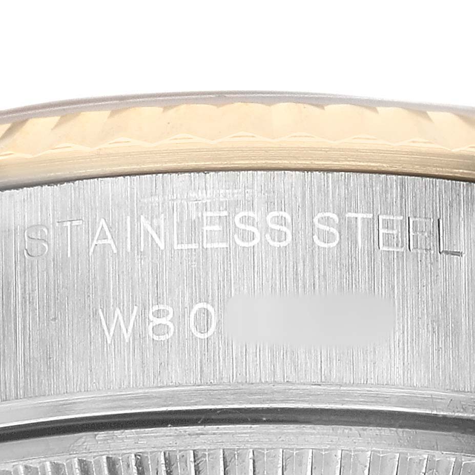The image shows a close-up of the Rolex Datejust 69173 Women's Steel and Gold (two tone) White Dial's case side, highlighting the stainless steel engraving.