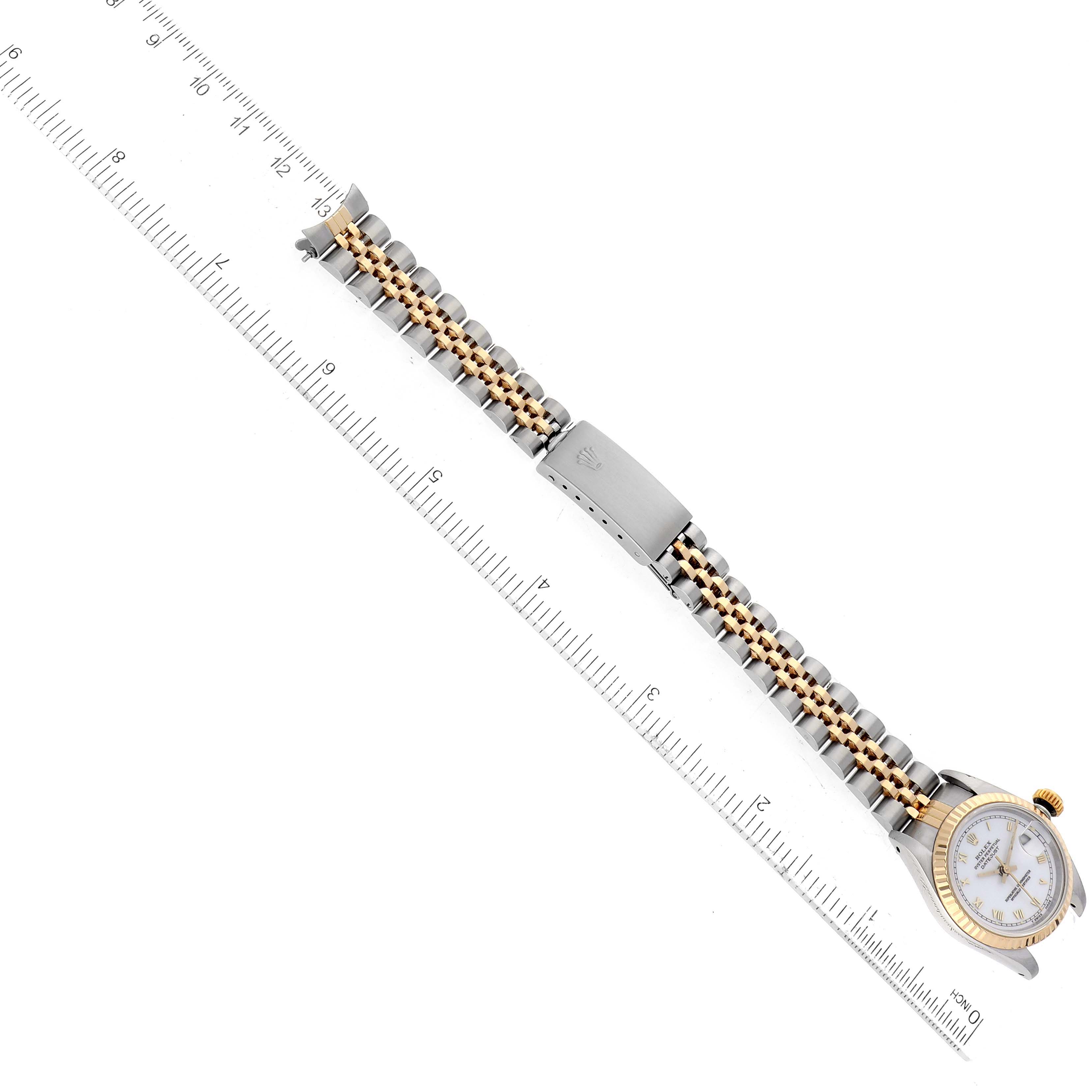 The image shows a top-down view of a Rolex Datejust 69173 Women's Steel and Gold (two tone) Champagne Dial 69173 Women's Steel and Gold (two tone) Champagne Dial watch, primarily highlighting its bracelet and clasp alongside a ruler for scale.