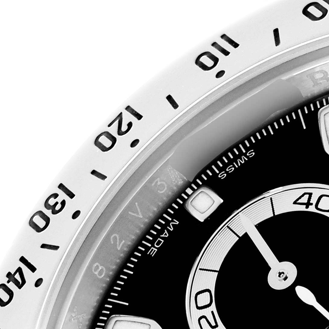 The image shows a close-up of the dial and tachymetric bezel of a Rolex Daytona model 116520 men's watch, featuring partial indices and the second sub-dial.
