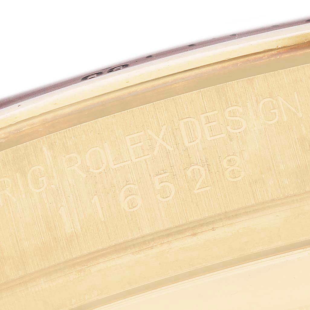 The image shows a close-up of the engraved edge of a Rolex Daytona model, number 116528, highlighting its model details.
