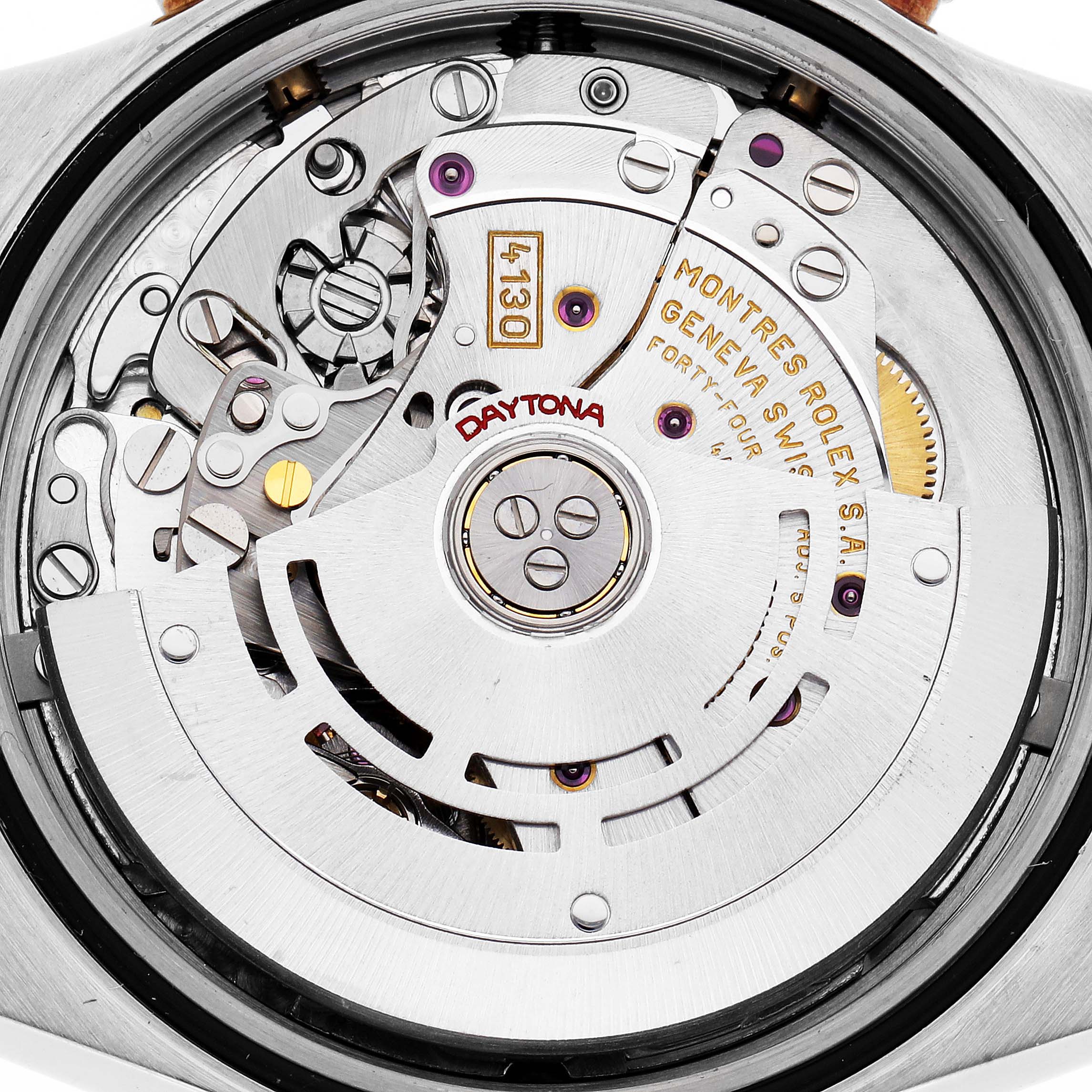 The image shows the movement of a Rolex Daytona model 116523 watch from a close-up, partial view, highlighting its intricate internal mechanics.