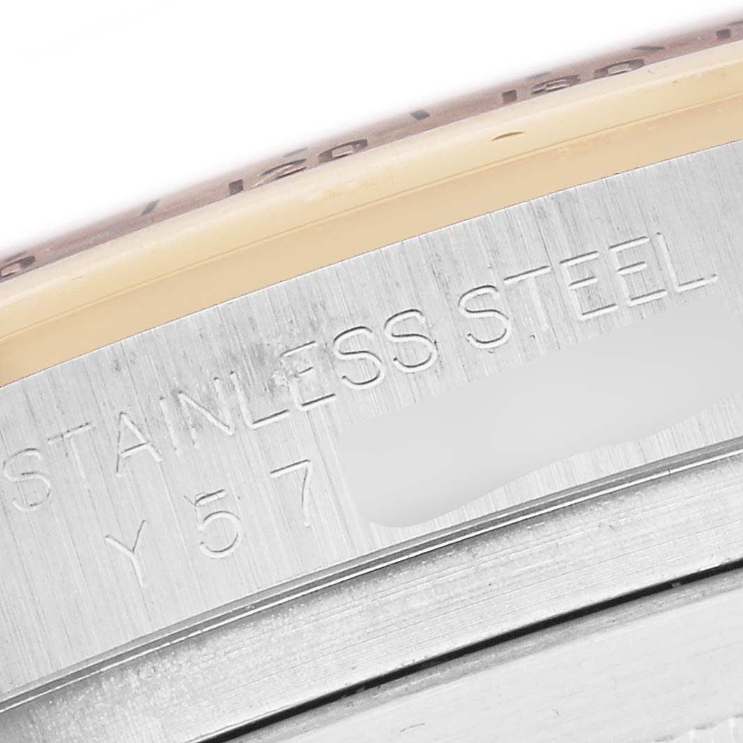 The image shows a close-up angle of the case side of the Rolex Daytona model, model number 116523, featuring "STAINLESS STEEL" engraving.