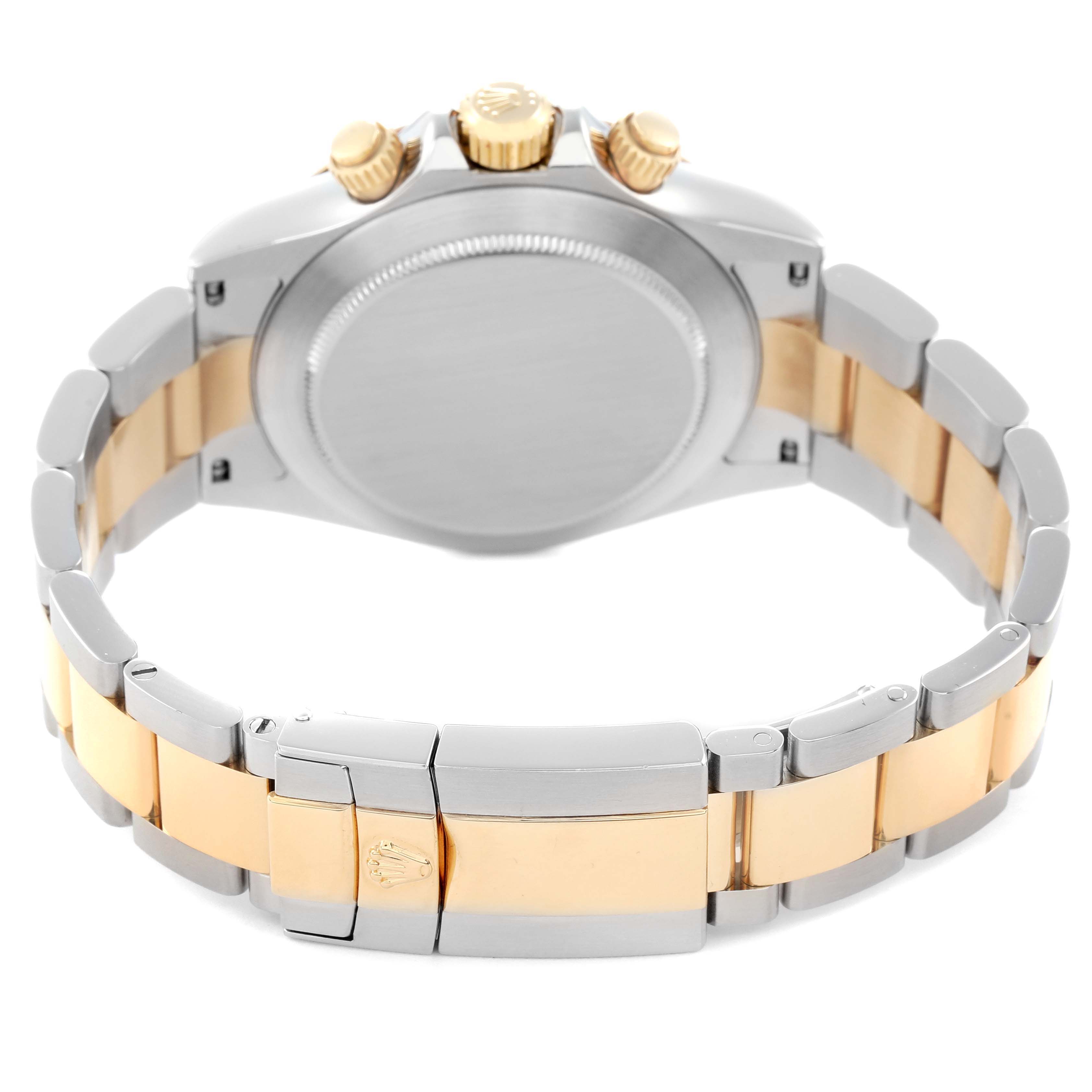 The image shows the back and side of a Rolex Daytona model 116523, highlighting its case, bracelet, and clasps in a two-tone design.
