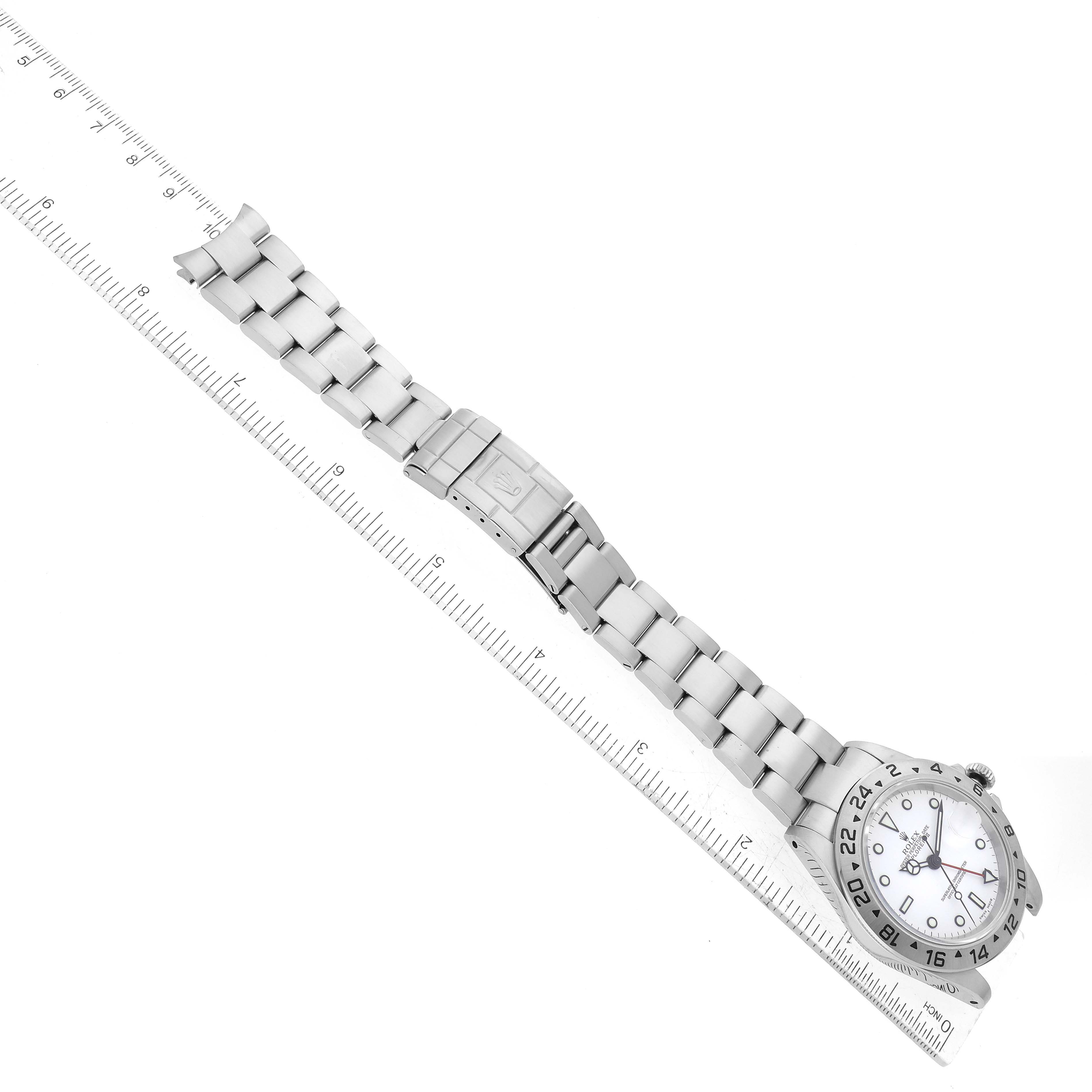 The image shows a Rolex Explorer 16570 Men's Stainless Steel White Dial 16570 Men's Stainless Steel White Dial watch laid flat, fully extended, with its band and clasp clearly visible, alongside a ruler for scale.