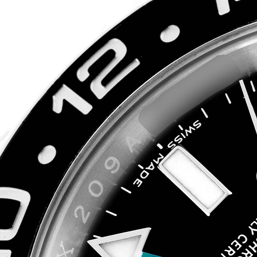 The image shows a close-up of the bezel and part of the dial of a Rolex GMT-Master model 116710, highlighting the "Swiss Made" text and hour markers.