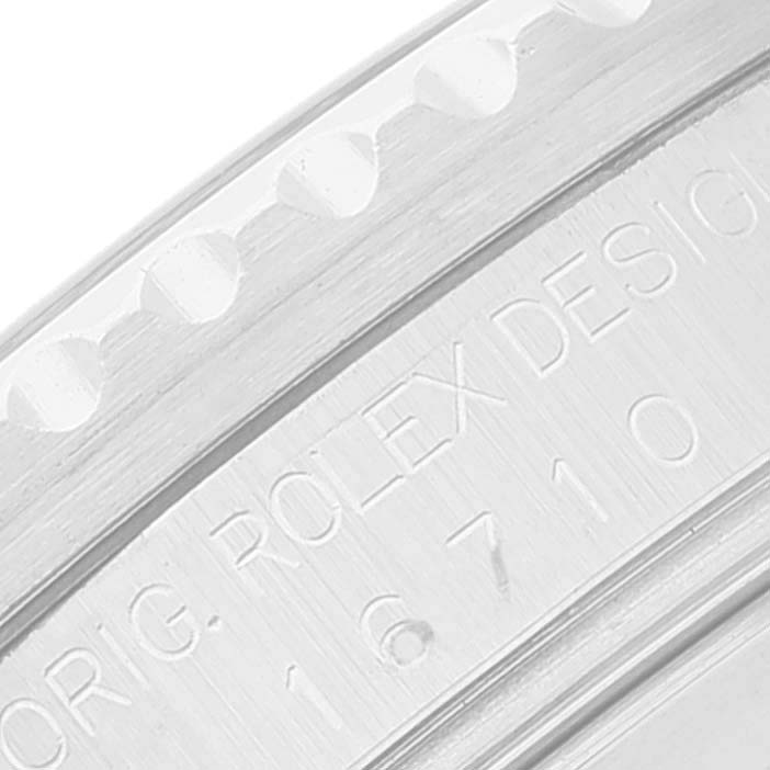 This is a close-up image of the engraved bezel and case of a Rolex GMT-Master 16710 Men's Stainless Steel Black Dial 16710 Men's Stainless Steel Black Dial model.