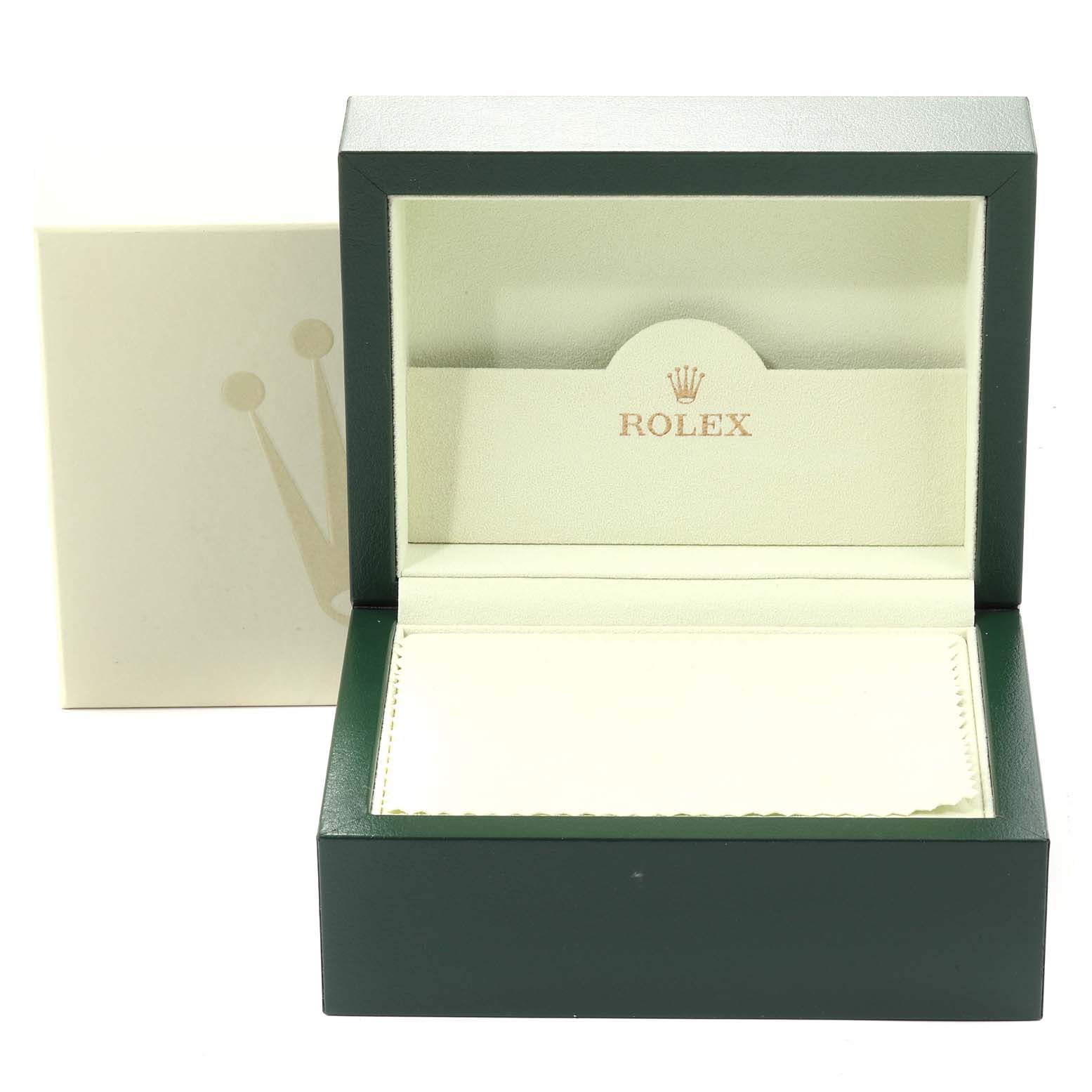The image shows an empty green Rolex box, presumably for a Milgauss model, with the brand logo and an inner cream holder.