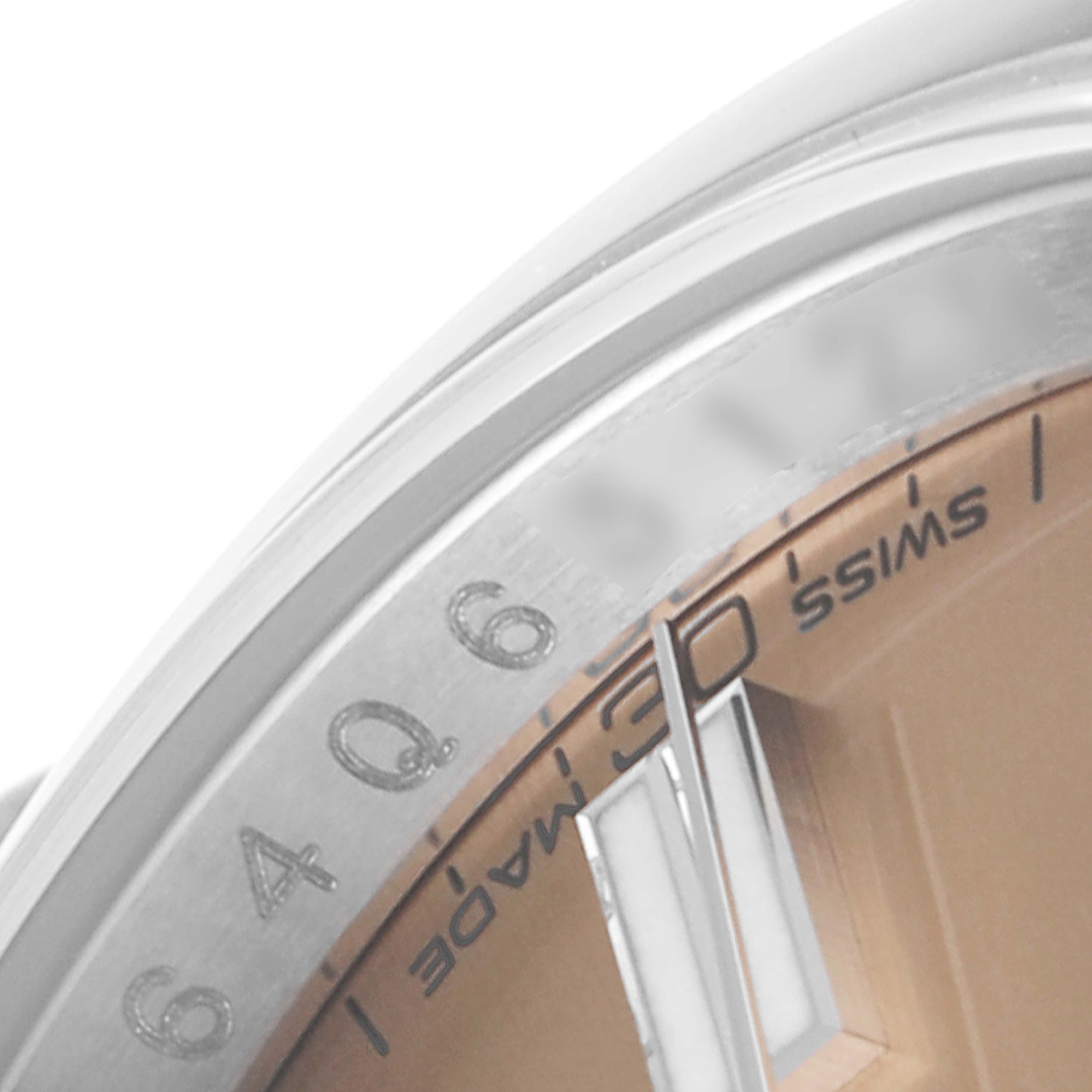The image shows a close-up of the dial, bezel, and part of the markers of an Oyster Perpetual watch by Rolex.