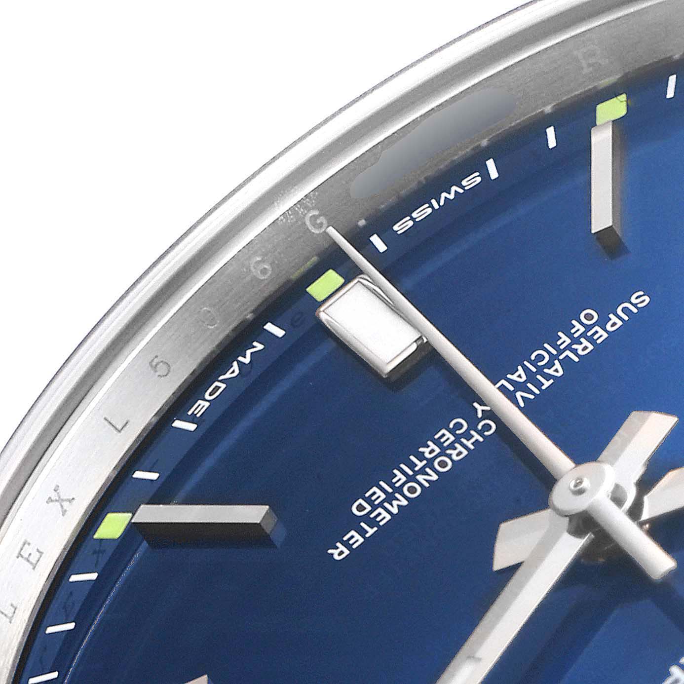 This close-up image shows the upper part of the dial and hands of a Rolex Oyster Perpetual 114300 Men
s Stainless Steel Blue Dial 114300 Men
s Stainless Steel Blue Dial watch.