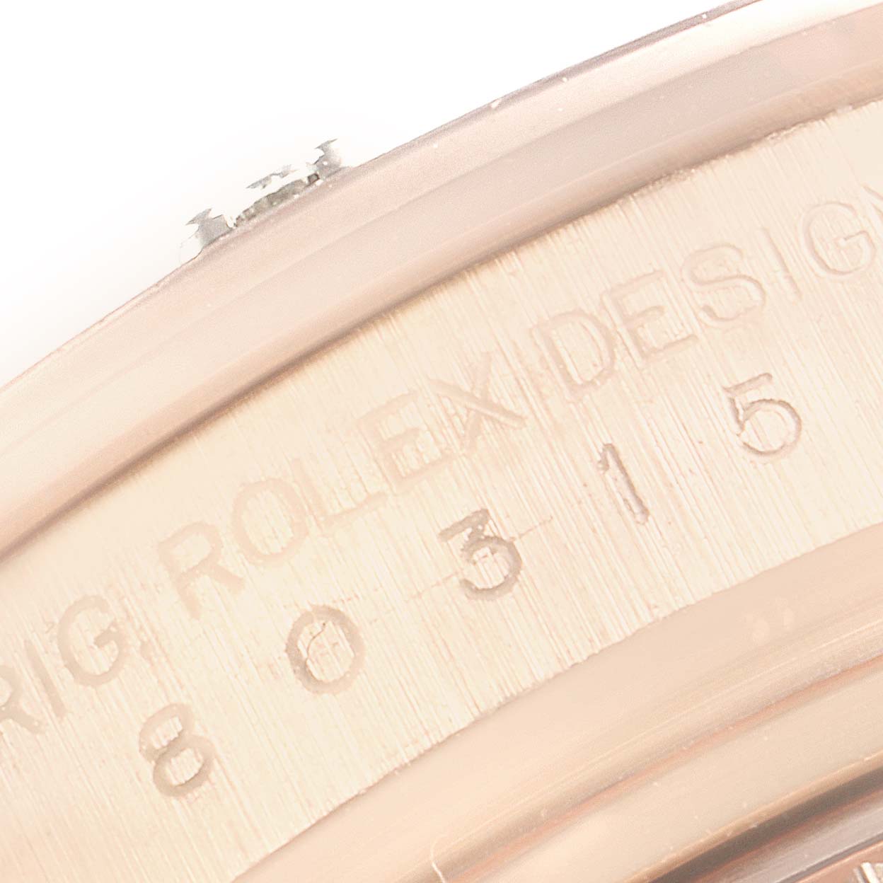 This close-up image of the Rolex Pearlmaster 80315 Women's Rose Gold Brown Dial 80315 Women's Rose Gold Brown Dial shows the engraved model number on its case side.