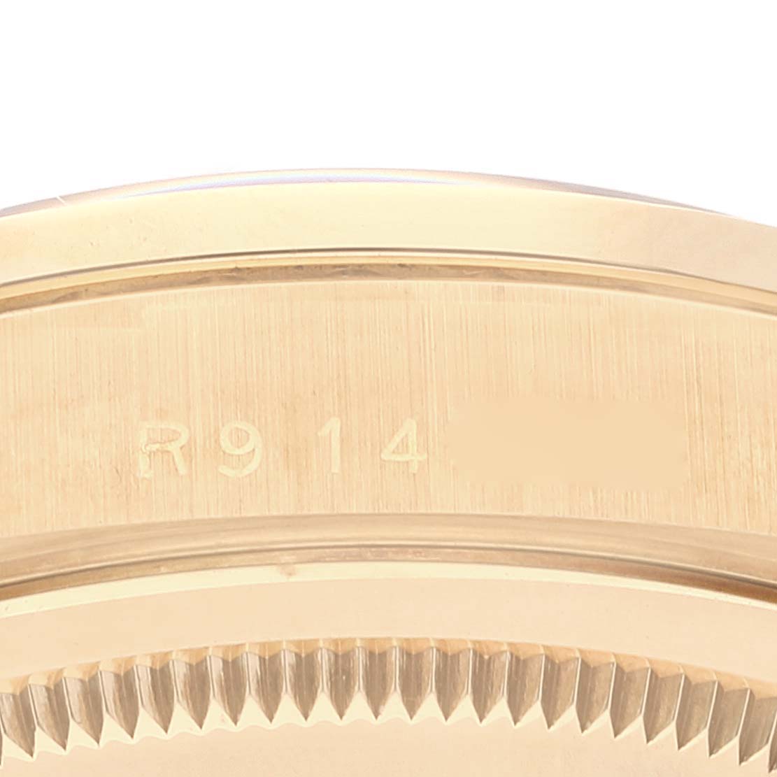 This image shows a close-up of the bezel and serial number on a Rolex President 18348 Men's Yellow Gold Champagne Dial 18348 Men's Yellow Gold Champagne Dial model watch.