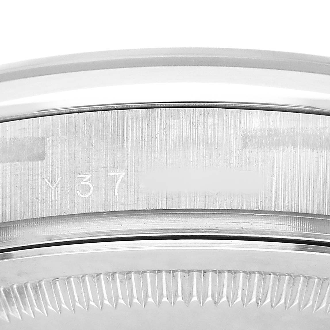 The image shows a close-up of the side engraving and bezel of a Rolex President 118209 Men's White Gold Silver Dial model watch.
