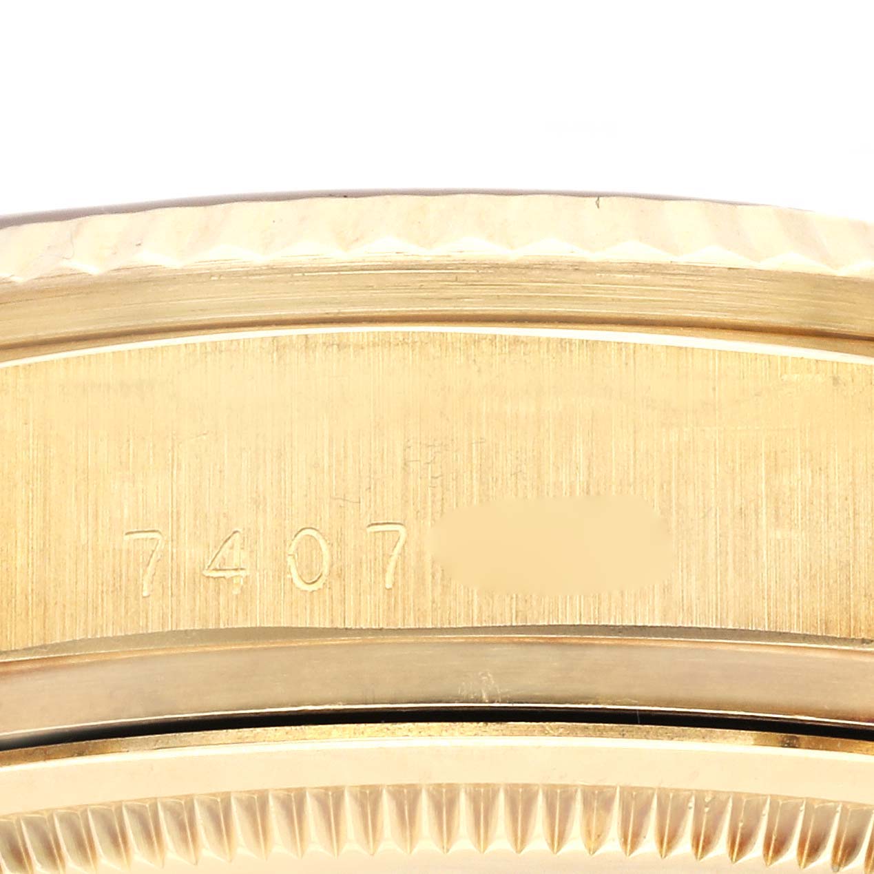 The image shows the side casing and part of the bezel of a Rolex President 18038 Men
s Yellow Gold Champagne Dial 18038 Men
s Yellow Gold Champagne Dial model watch, with serial numbers inscribed.