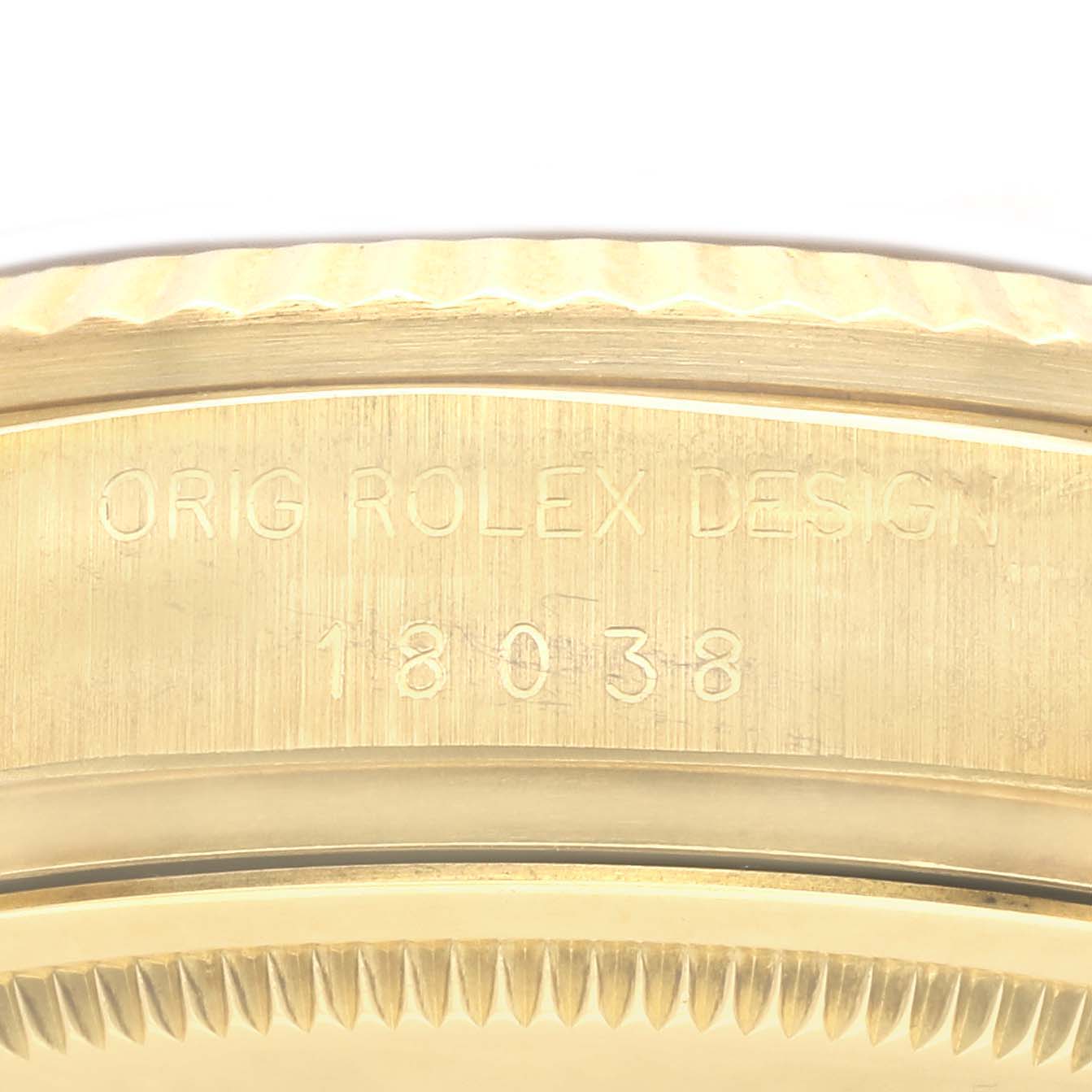 The image shows a close-up of the case back and edge of a Rolex President 18038 Men
s Yellow Gold Champagne Dial 18038 Men
s Yellow Gold Champagne Dial model with the engraving "ORIG ROLEX DESIGN 18038."