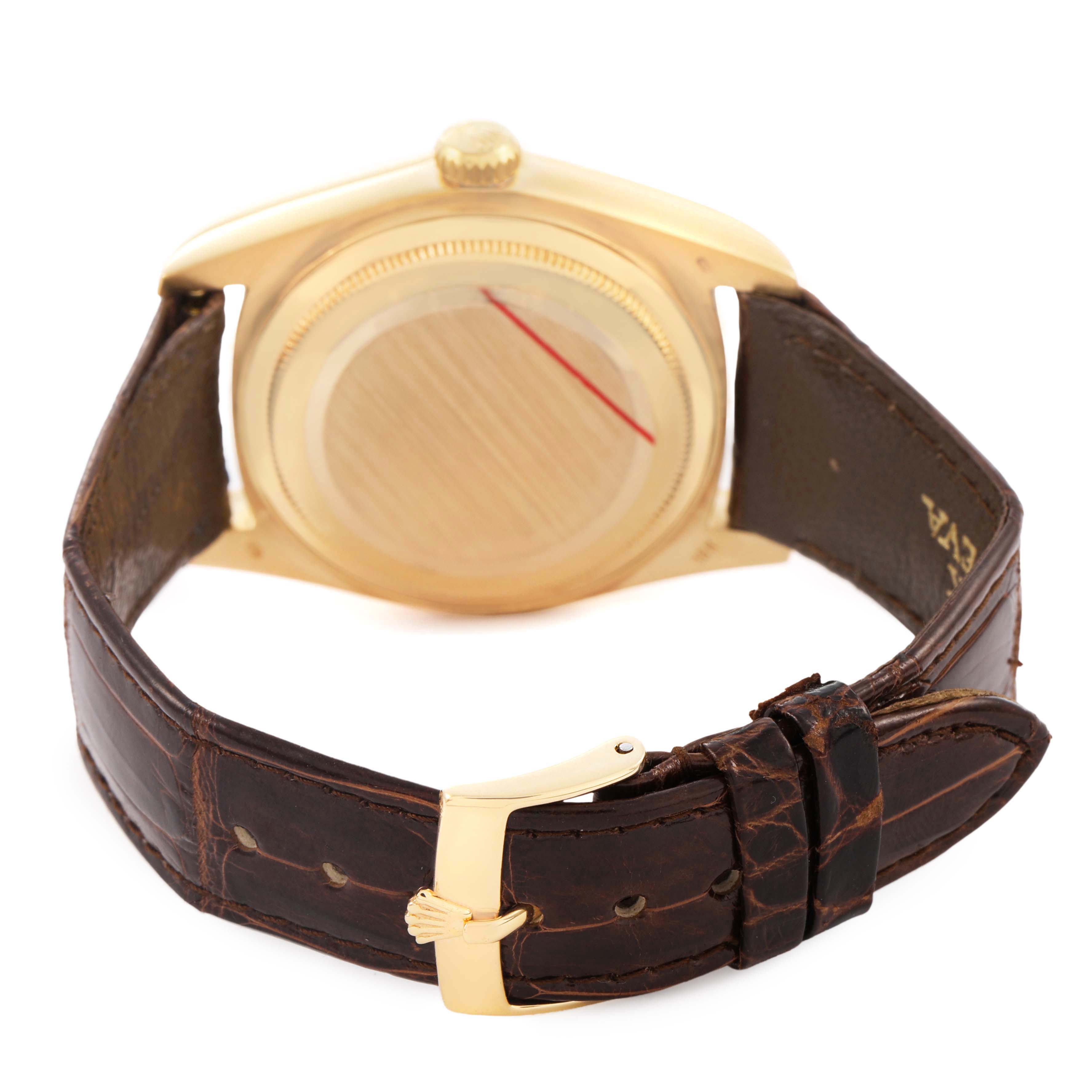 The Rolex President 18038 Men's Yellow Gold Champagne Dial model is shown from the back, featuring the case, crown, and brown leather strap with a gold buckle.