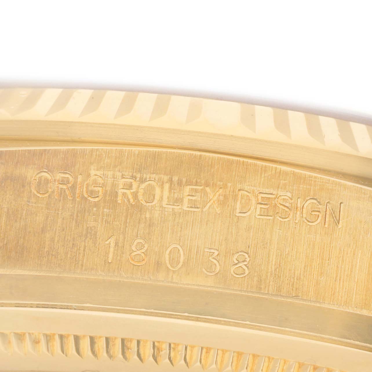 The image shows a close-up of the engraved edge on a Rolex President 18038 Men's Yellow Gold Champagne Dial model, highlighting "ORIG ROLEX DESIGN" and model number 18038.