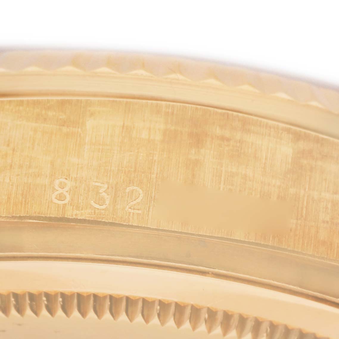The image shows a close-up of the side of a Rolex President 18038 Men's Yellow Gold Champagne Dial watch, highlighting the serial number engraving.