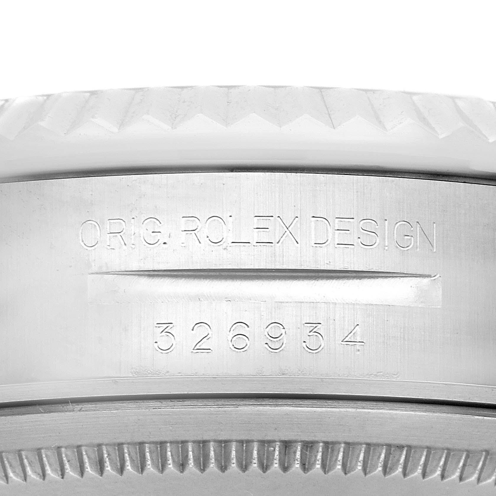 The image shows a close-up of the Rolex Sky-Dweller model 326934, focusing on the engraved design and model number on the watch case.