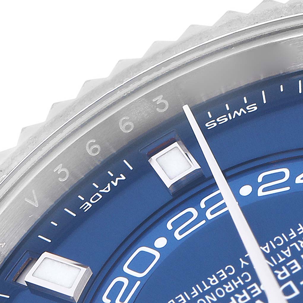 This image shows a close-up of the dial and part of the bezel of a Rolex Sky-Dweller model 326934, featuring a blue dial with partial markers.