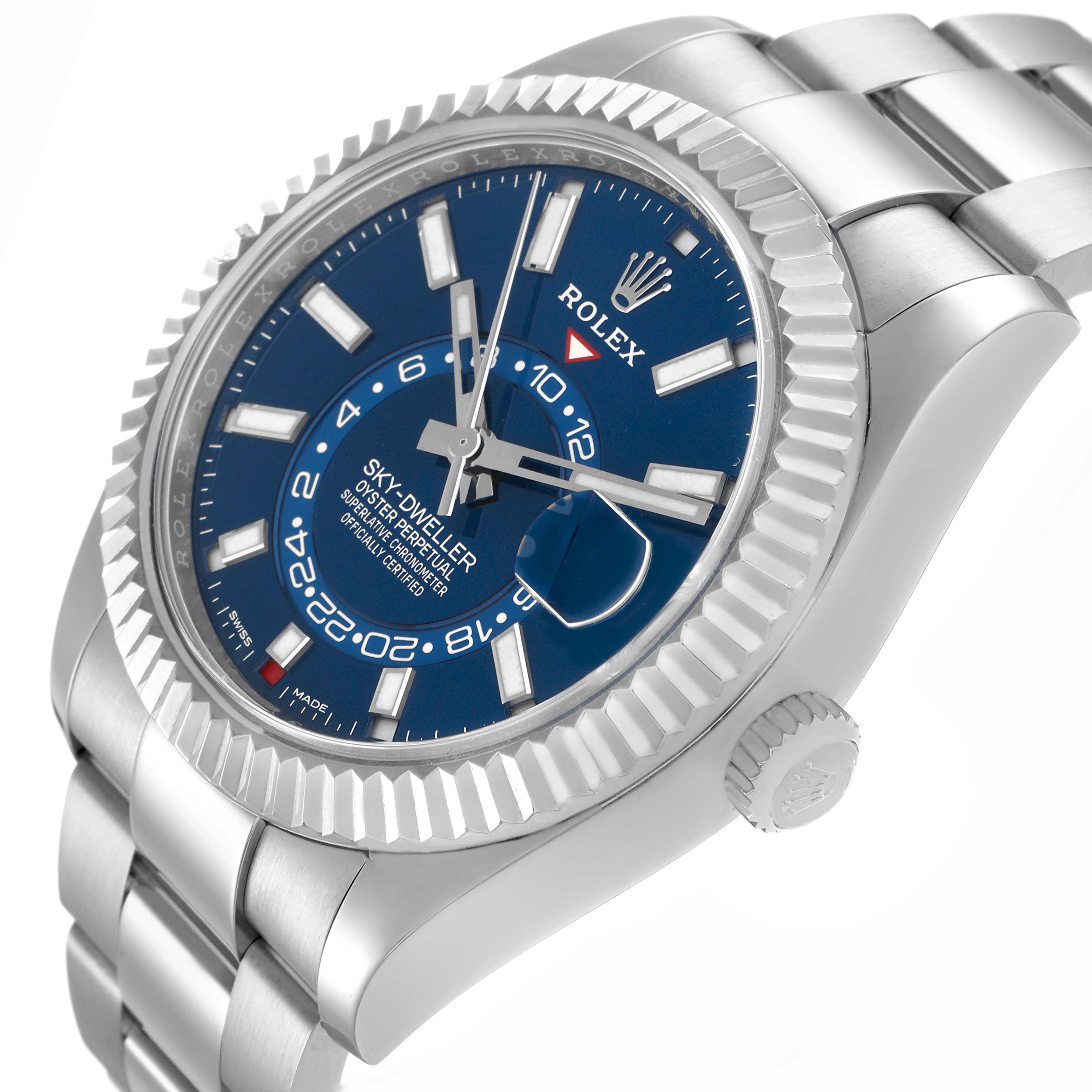 The Rolex Sky-Dweller model 326934 is shown at an angled view, highlighting the blue dial, fluted bezel, crown, and part of the bracelet.