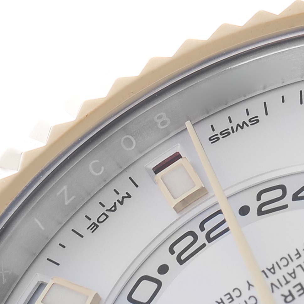 The image shows a partial close-up of the Rolex Sky-Dweller model 326933, featuring the edge of the bezel, part of the dial, and markers, viewed from an oblique angle.