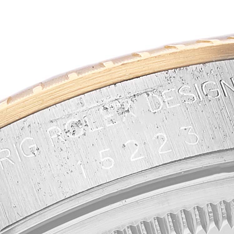 The image shows a close-up of the side case and fluted bezel of a Rolex Date 15223 Men's Steel and Gold (two tone) Grey Dial 15223 Men's Steel and Gold (two tone) Grey Dial model.