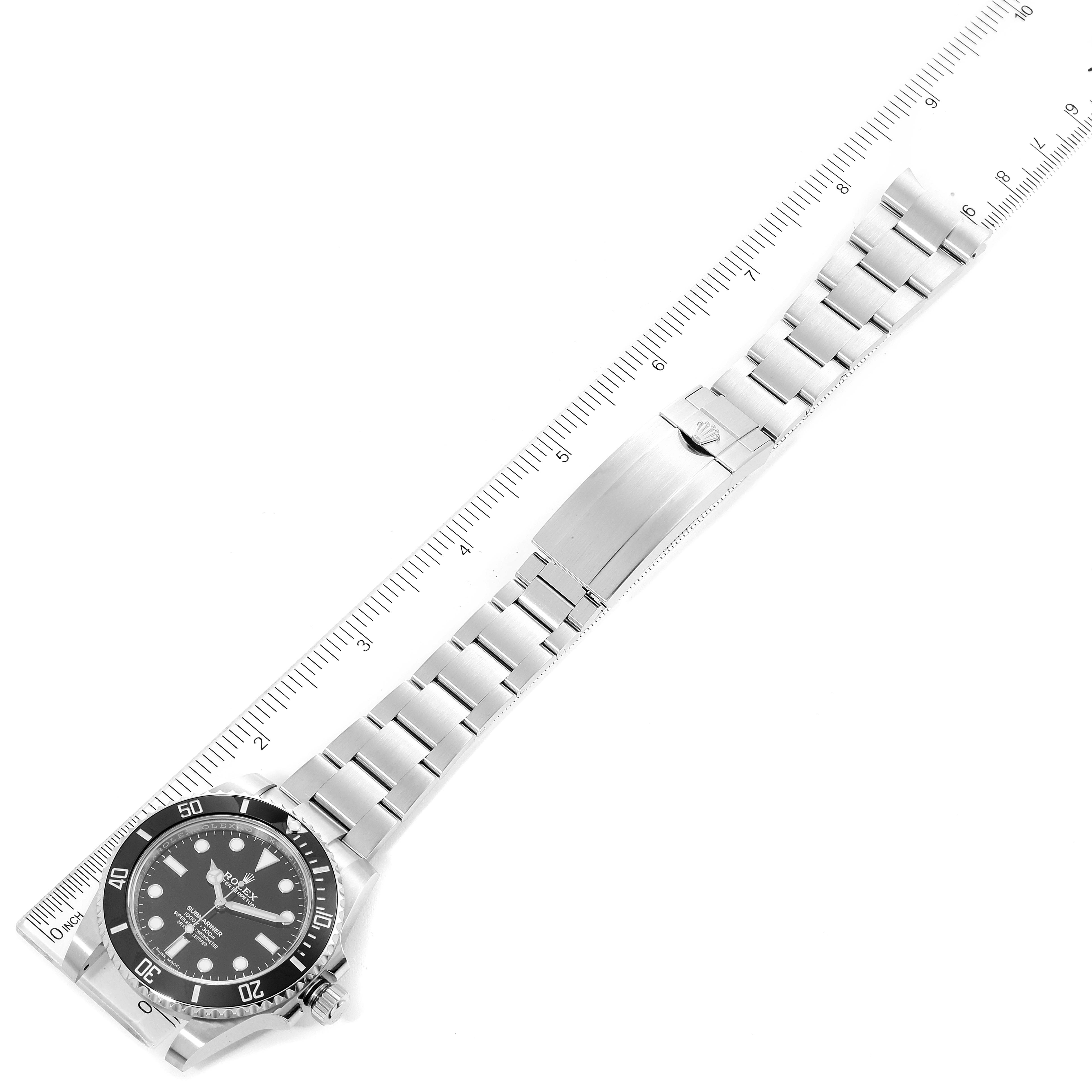 The image shows a Rolex Submariner 114060 Men's Stainless Steel Black Dial 114060 Men's Stainless Steel Black Dial watch laid flat with a view of the face and entire bracelet alongside a ruler for measurement.