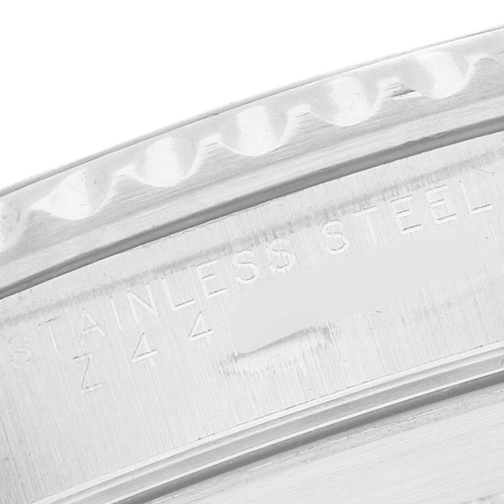 The image shows a close-up of the back or inner bezel of a Rolex Submariner, model 14060, highlighting the textured stainless steel finish and engraved markings.