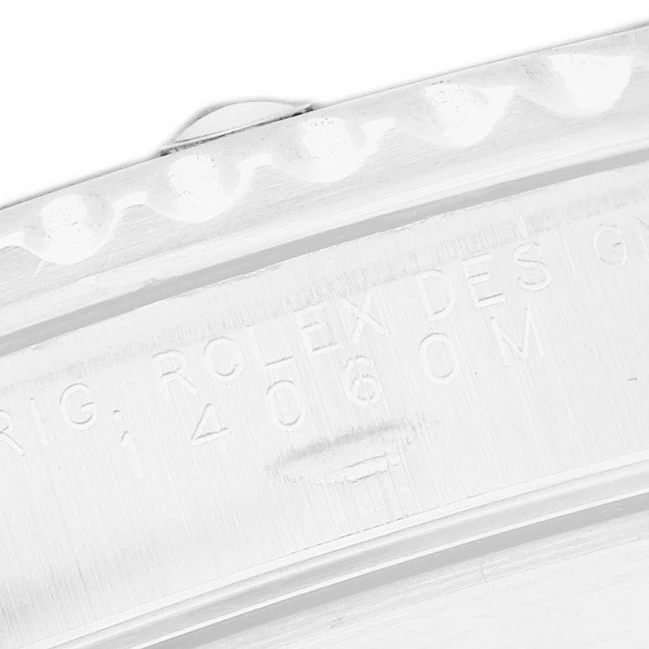 The image shows a close-up of the case back of a Rolex Submariner model 14060, highlighting the engraved model number and the bezel's edge.