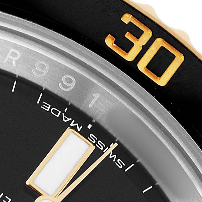 The image shows a close-up of a Rolex Submariner 116613 Men's Steel and Gold (two tone) Black Dial's watch face, bezel marked "30," and part of the minute and hour markers.