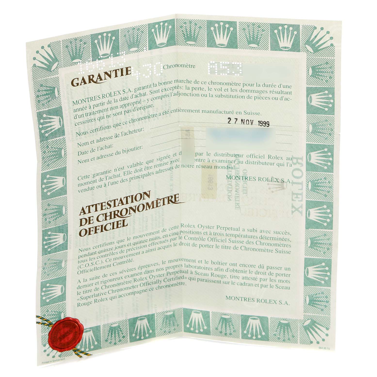 The image shows the warranty and certificate for a Rolex Submariner model 16613, displayed open with text and decorative elements visible.