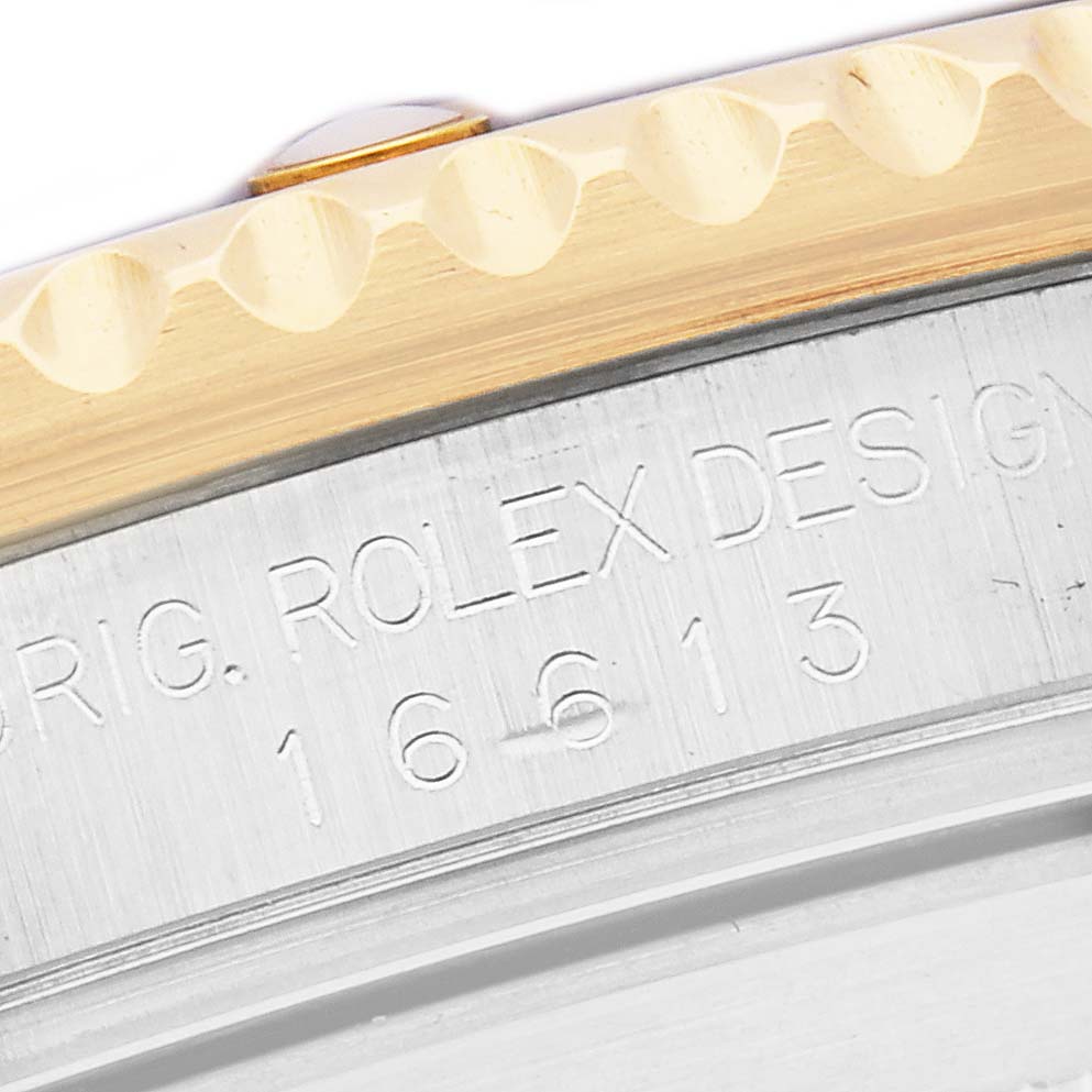 The image shows a close-up of the case side of the Rolex Submariner, model 16613, featuring the bevel and engraved model number.
