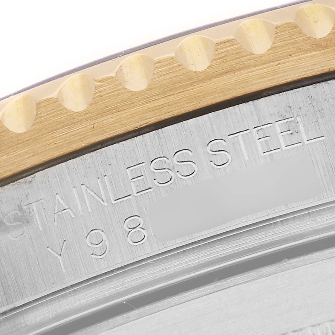 The image shows a close-up of the bezel and part of the case back of a Rolex Submariner 16613 Men's Steel and Gold (two tone) Grey Dial 16613 Men's Steel and Gold (two tone) Grey Dial watch, highlighting the "STAINLESS STEEL" engraving.