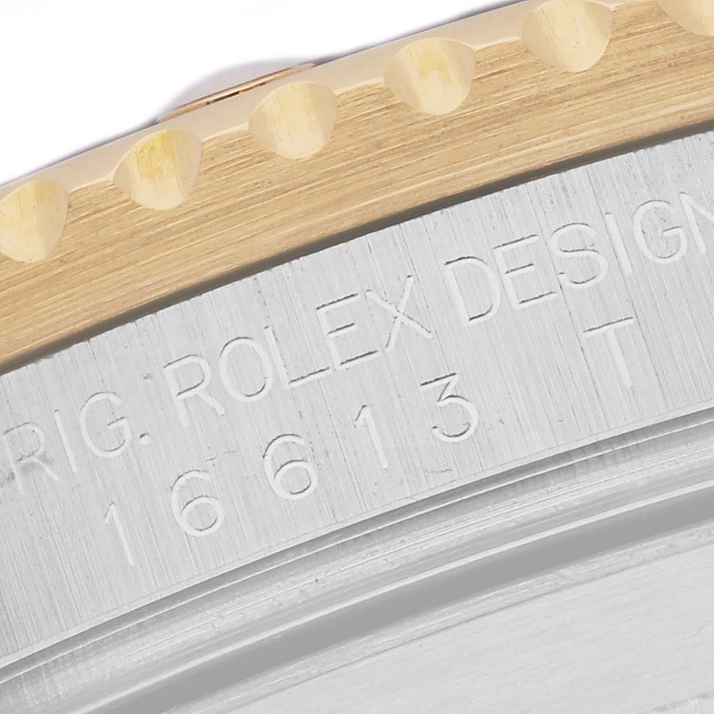 Close-up of the side showing the engraved model number and brand name of a Rolex Submariner 16613 Men's Steel and Gold (two tone) Grey Dial 16613 Men's Steel and Gold (two tone) Grey Dial watch.