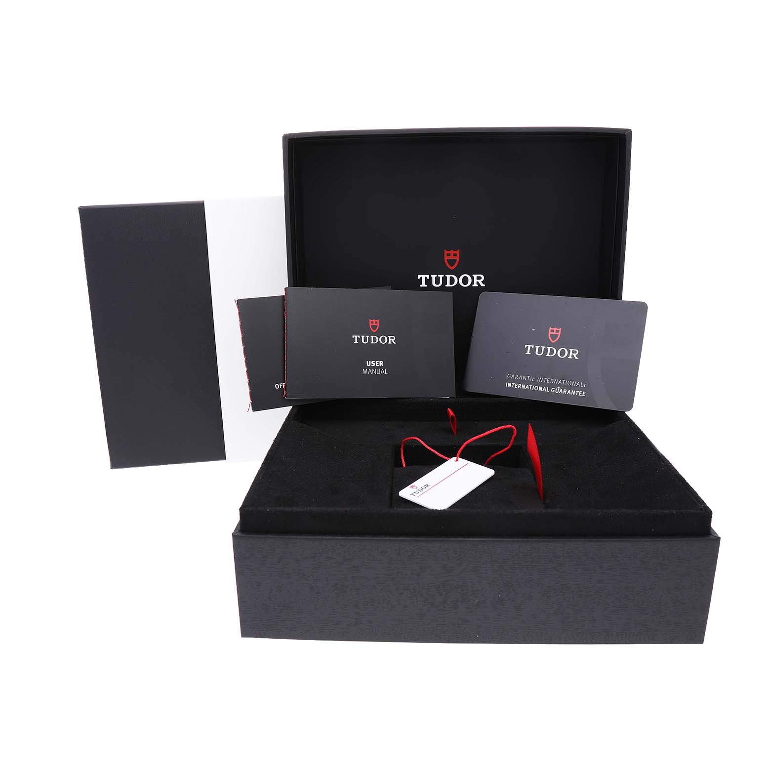 The image shows the packaging and accessories for the Tudor Heritage Black Bay 79640 Men's Stainless Steel Blue Dial, including a box, manual, and tags.